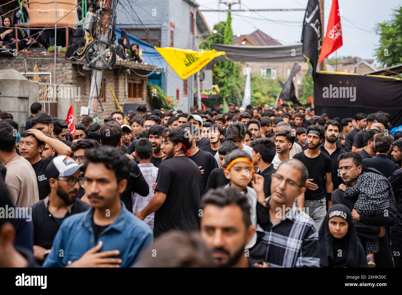 Srinagar, India. 14th July, 2024. Kashmiri Shia Muslims walk in a ...