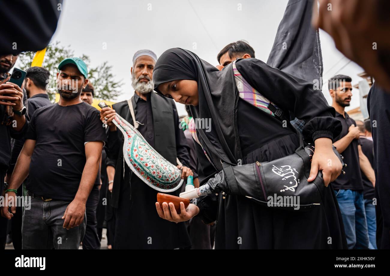 Srinagar, India. 14th July, 2024. A Kashmiri Shia Muslim girl ...