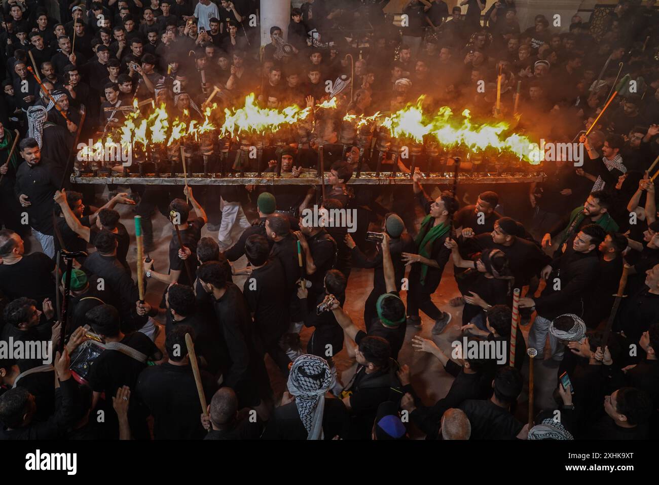 Najaf, Iraq. 14th July, 2024. Shiite Muslims perform mourning rituals ...