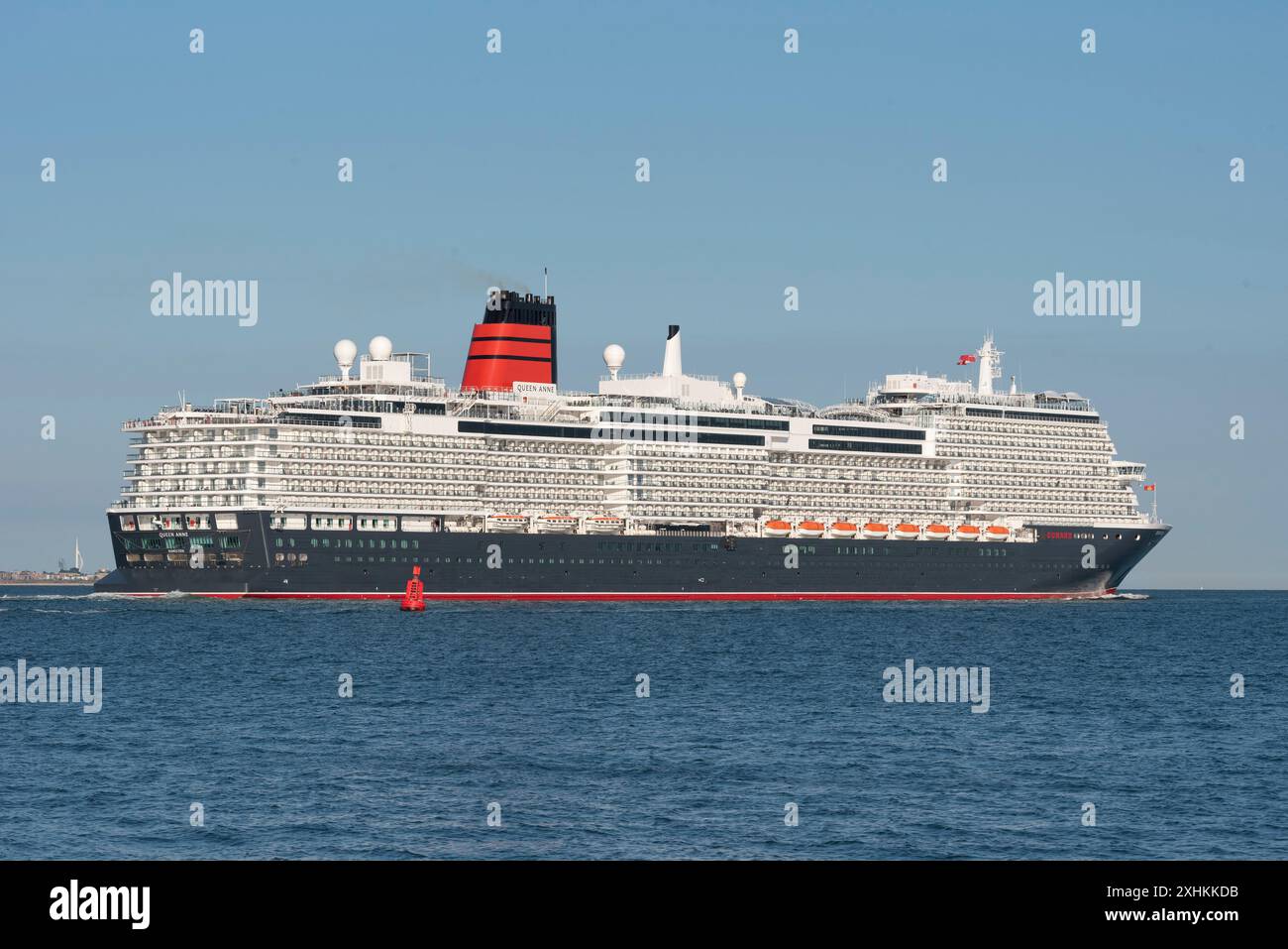 Southampton Water, England, UK. 14. 07.2024. Recently launched the cruise liner Queen Anne underway sailing down Southampton Water to the open sea. Stock Photo