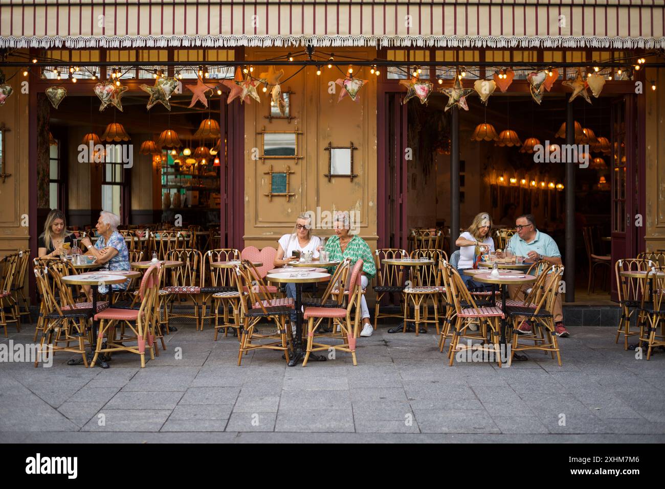 Paris, France, people sitting on the patio of a restaurant in Paris enjoying their breakfast. Stock Photo