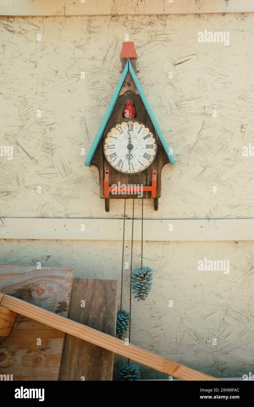 Vintage cuckoo clock on textured wall. Stock Photo