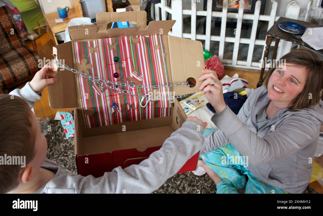 Mother and son looking at a homemade gift in a decorated box Stock Photo