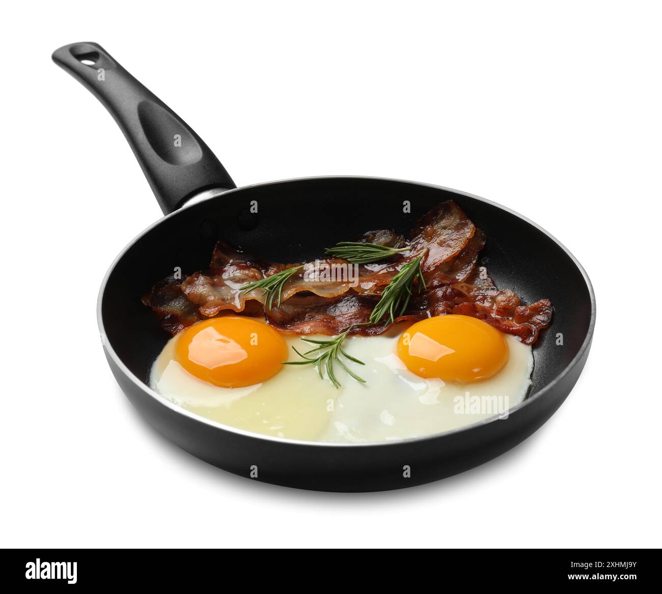 Tasty bacon, eggs and rosemary in frying pan isolated on white Stock ...