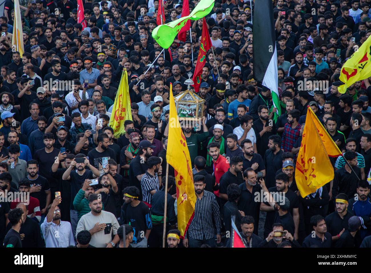 Kashmiri Shiite Muslims hold religious flags as they take part in the ...