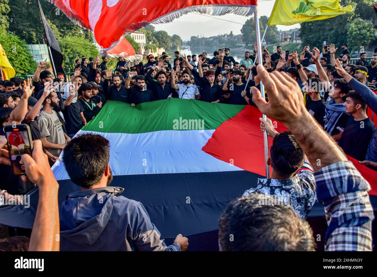 Srinagar, India. 15th July, 2024. Kashmiri Shiite Muslims shout slogans ...