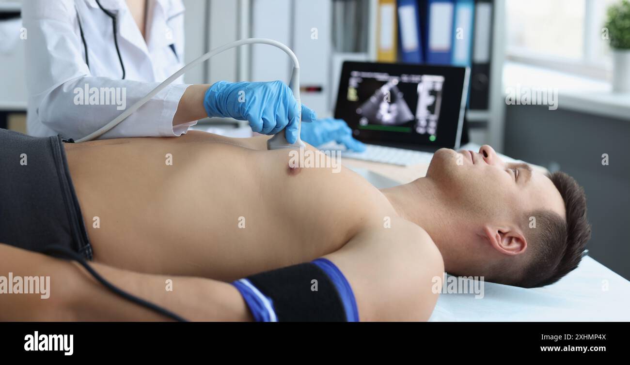 Doctor doing ultrasound of rib cage, cardiologist examining a patients ...