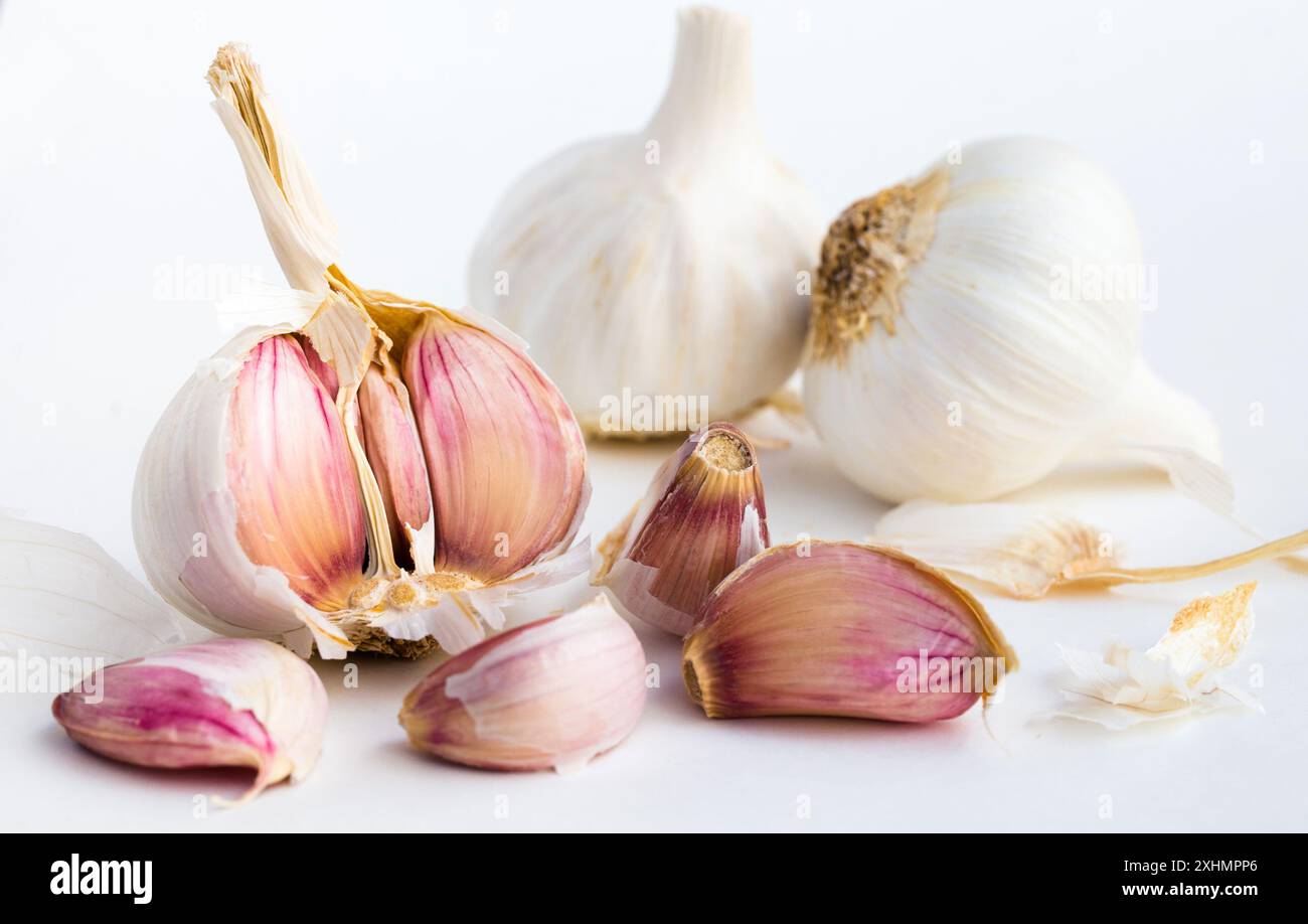 Garlic heads and cloves on white background Stock Photo - Alamy