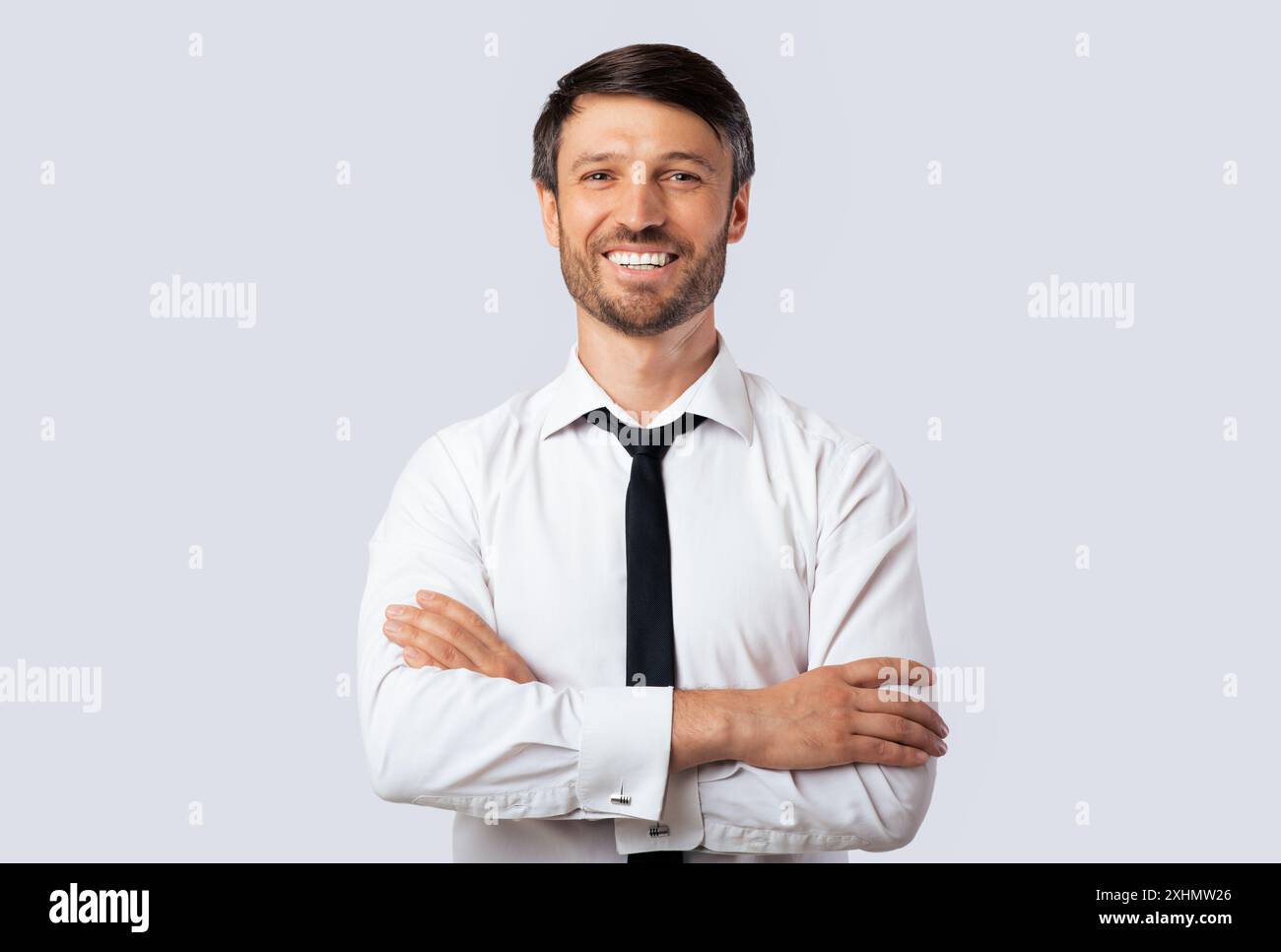 Business Guy Smiling Crossing Hands Standing Over White Background Stock Photo