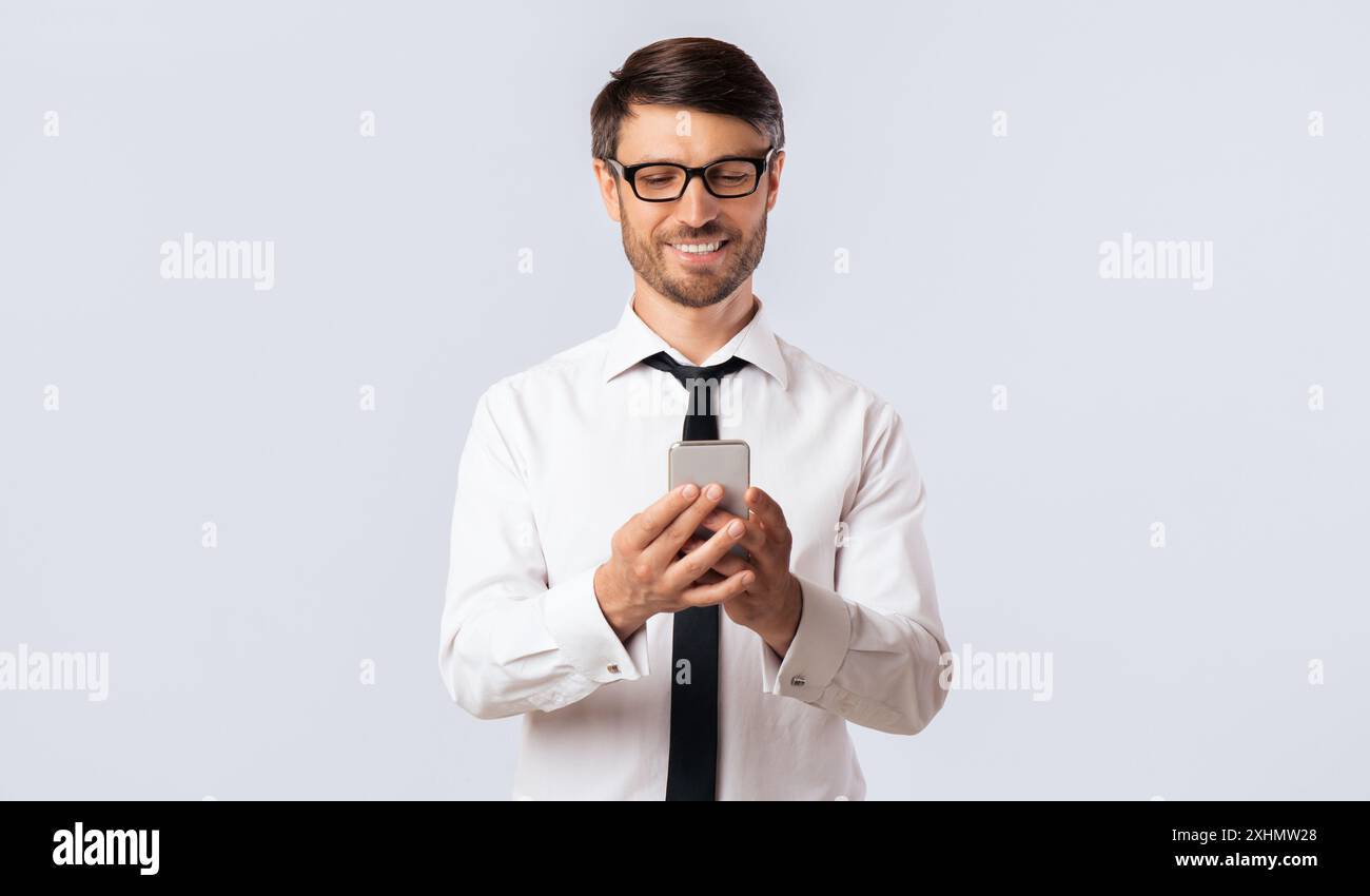 Smiling Man Using Smartphone Stock Photo