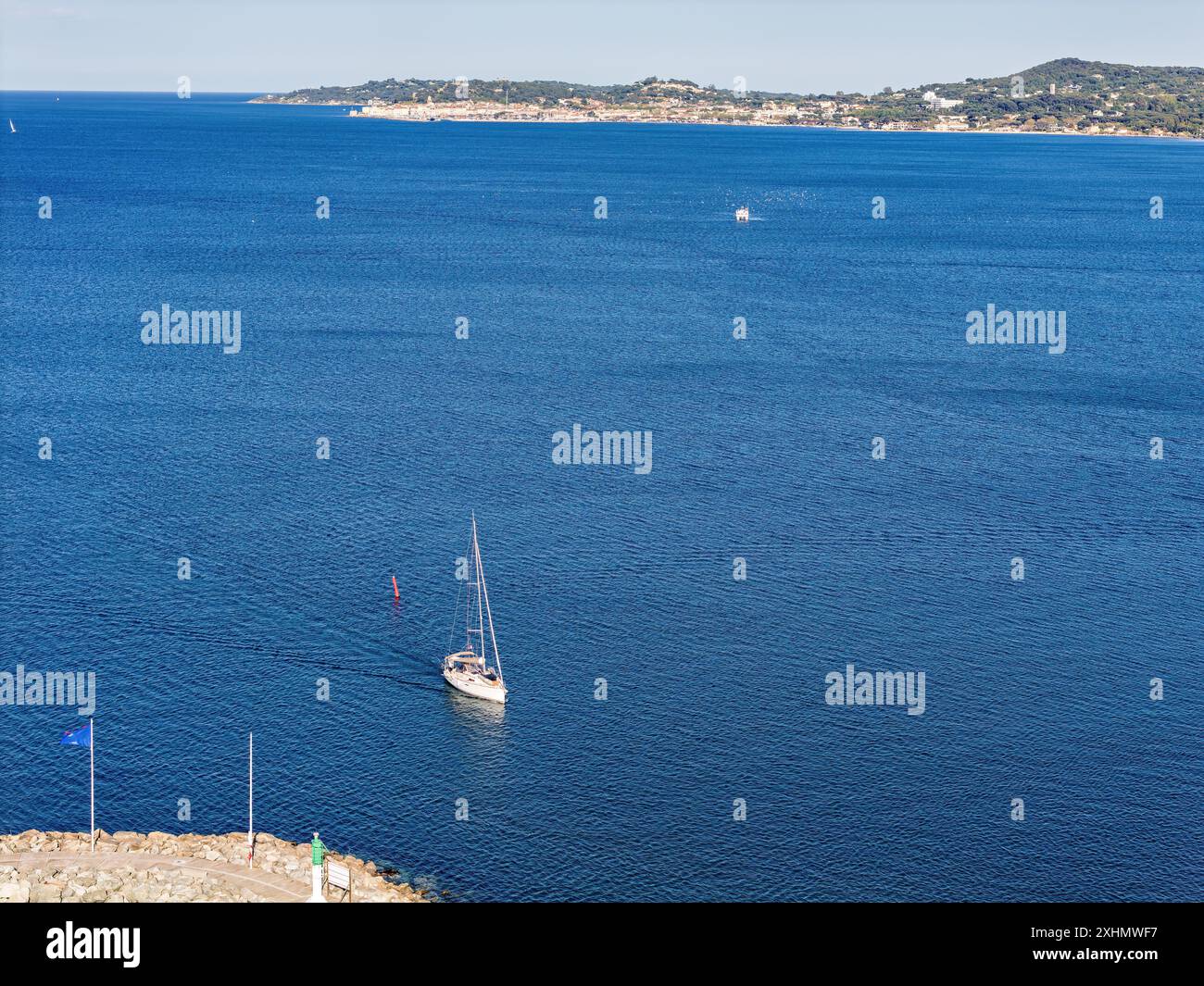 Beach with waves in Port Grimaud looking towards Saint Tropez in France in spring, close-up Stock Photo