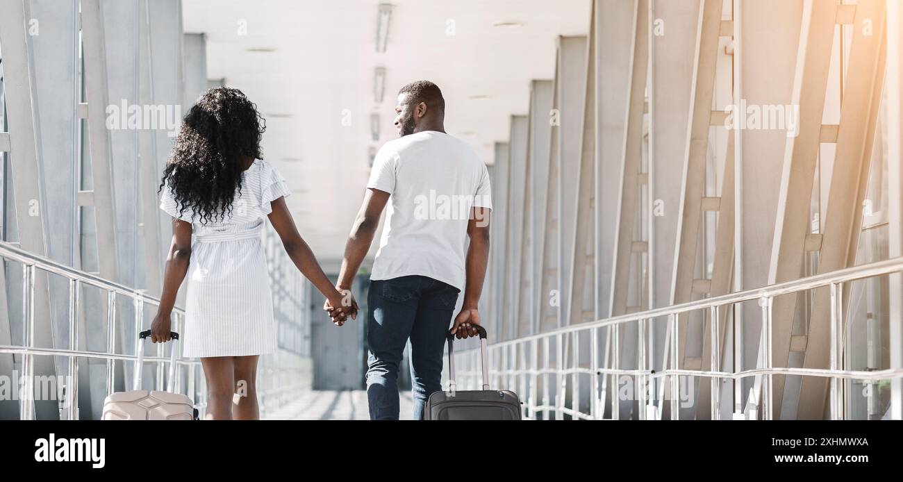 A Couple Walking Away With Luggage at an Airport Terminal Stock Photo ...