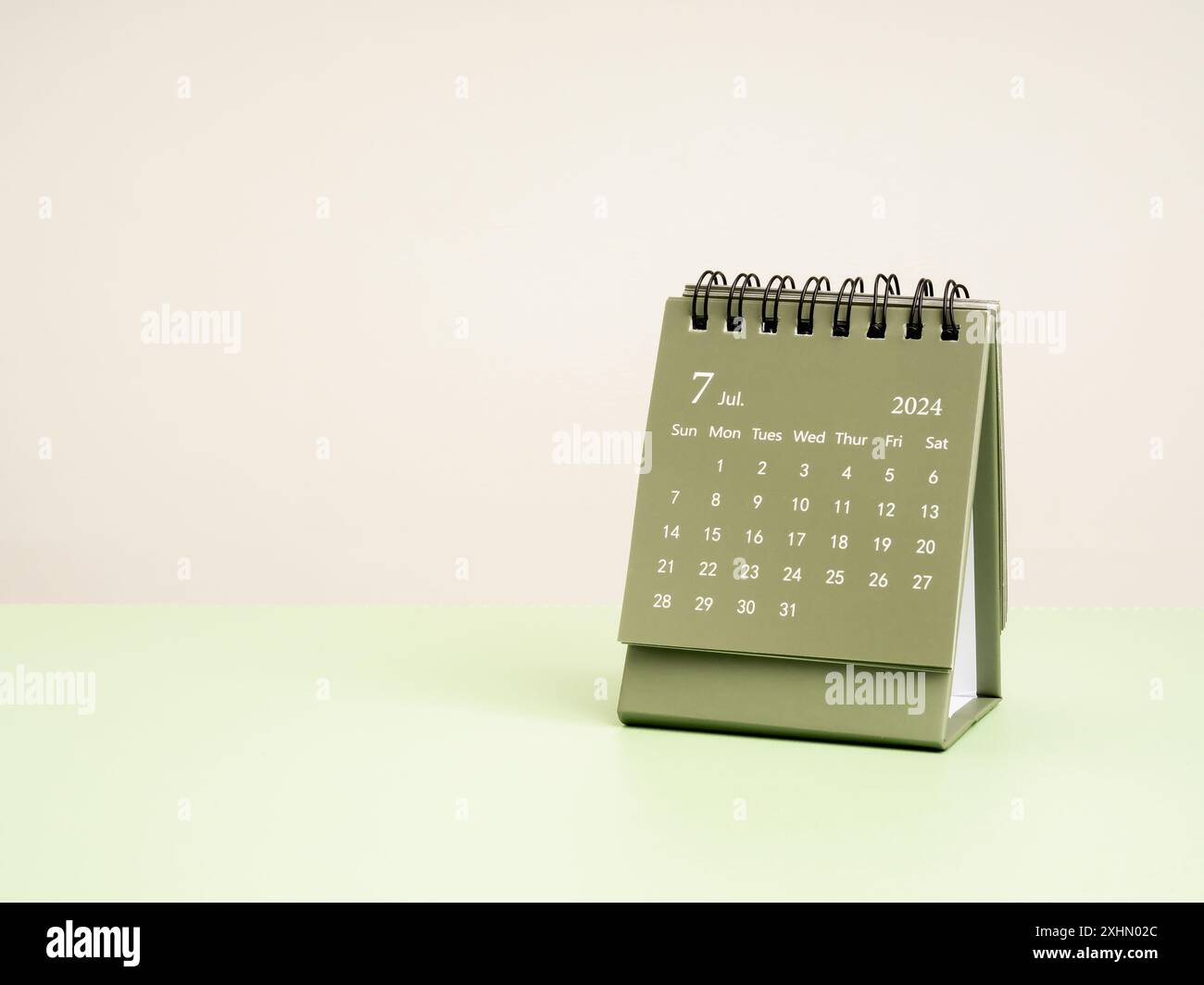 A July 2024 desk calendar for plan and reminder isolated on green table ...