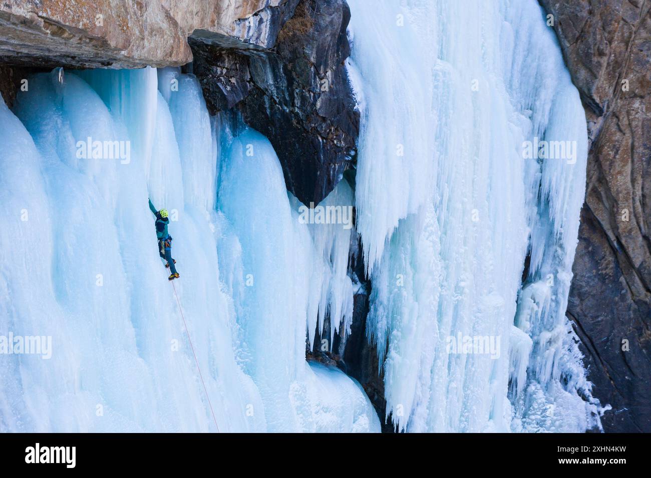Blue man climbing wall hi-res stock photography and images - Alamy