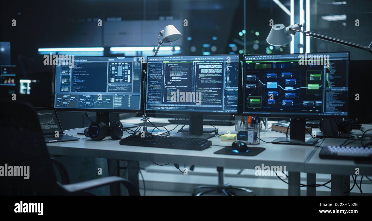 Empty Software Developer Office Workplace with a Desk with Multiple Computer Screen with Programming Code, Big Data Models, Back-End of Artificial Intelligence and Neural Network Technology Systems Stock Photo