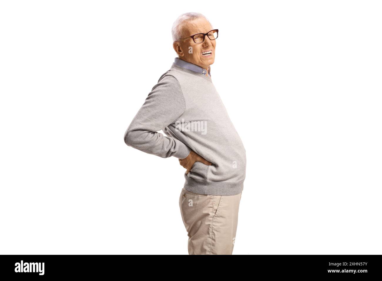 Elderly man in pain holding his lower back isolated on white background ...