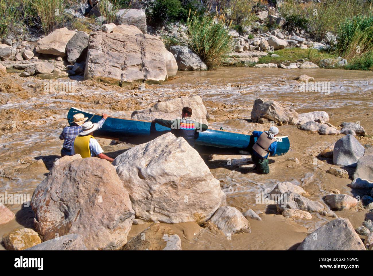 Canoeists lining a canoe to pass Hot Springs Rapids, The Lower Canyons ...