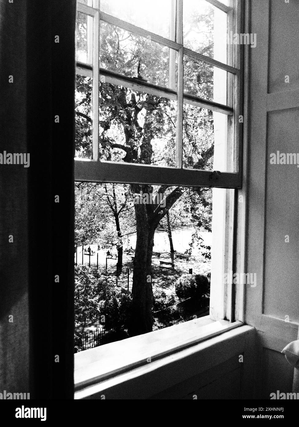 An open sash window looking out onto a lovely park in the summer ...