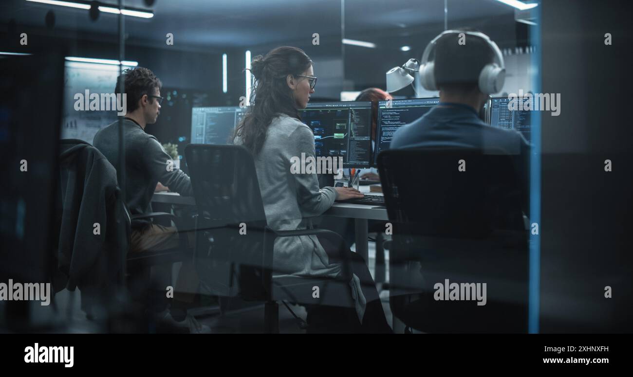 Group of Multicultural Men and Women Working in a Research Center, Collaborating and Discussing a Project, Using Computers to Write Advanced Software Code, Develop Artificial Intelligence Service Stock Photo