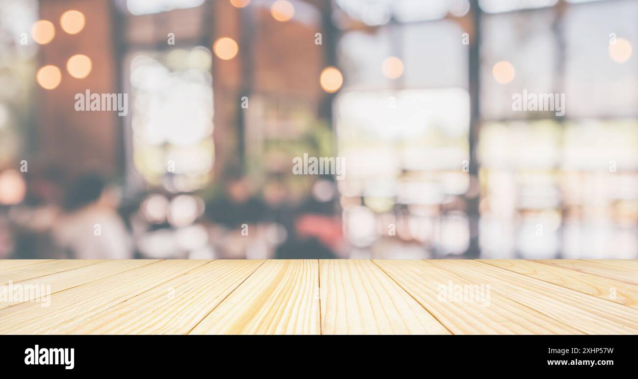 Empty Wood table top with Restaurant cafe or coffee shop interior with ...