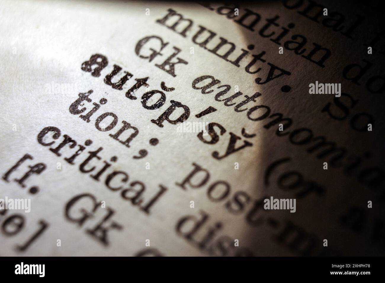 Word autopsy on dictionary page, macro close-up Stock Photo