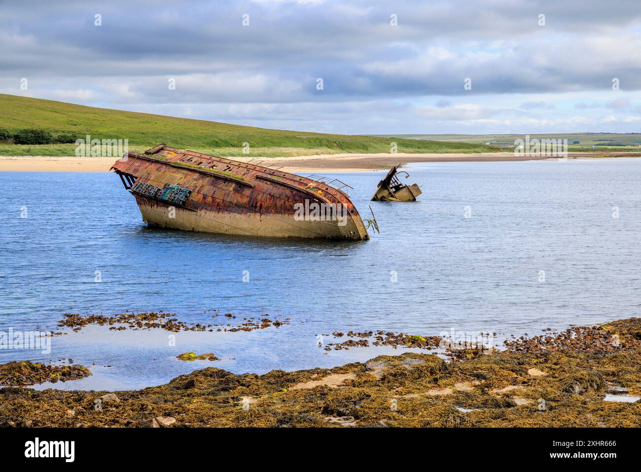 Scuttled boats next to Churchill Barrier No. 3 in Weddell Sound,  Orkney Islands, North Scotland Stock Photo