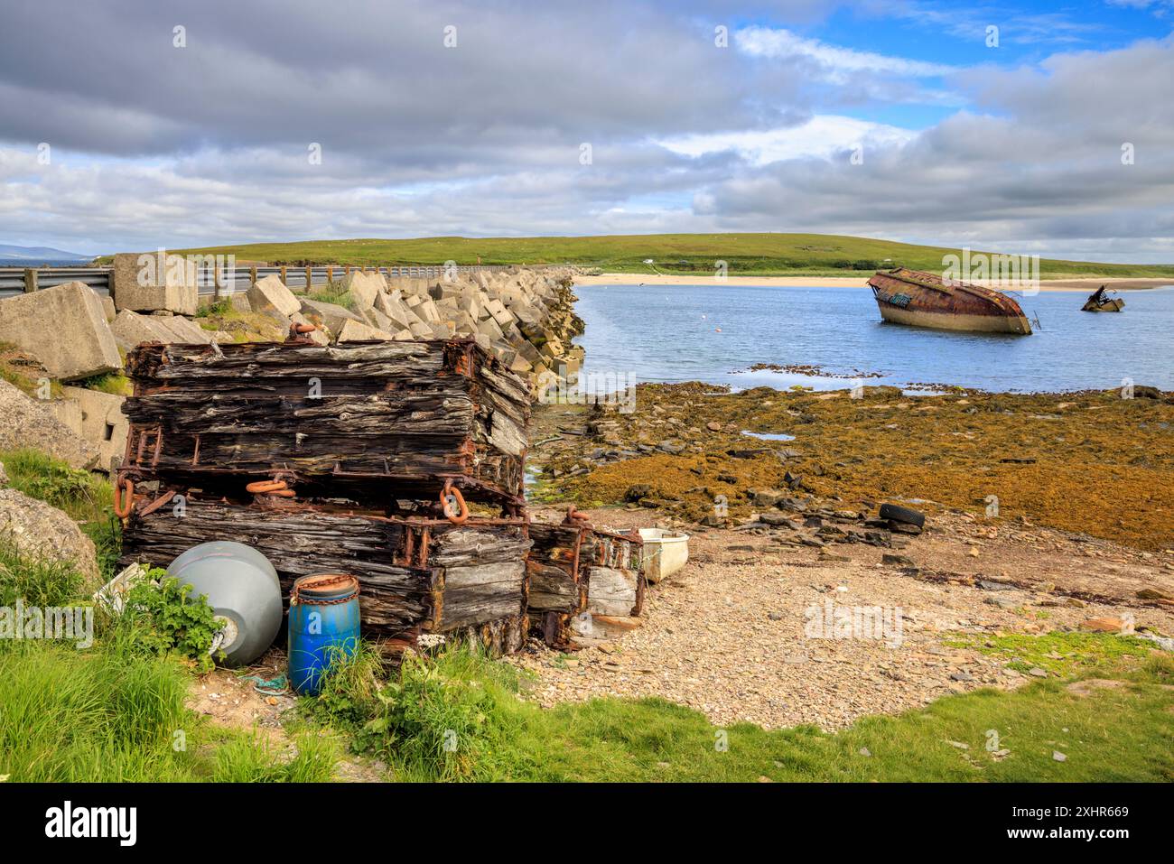 Scuttled boats next to Churchill Barrier No. 3 in Weddell Sound,  Orkney Islands, North Scotland Stock Photo