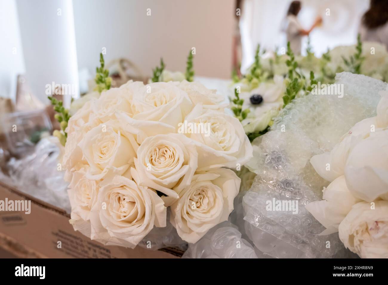 White Roses Reflected Bridal bouquet of white roses lying in front of mirror with bride ...