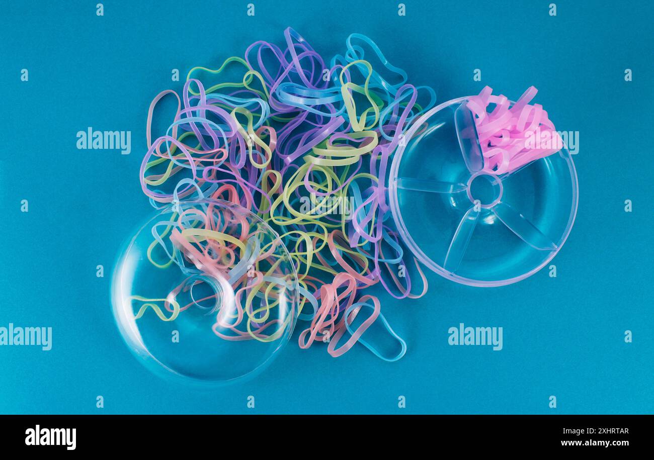 Open donut shaped container with colorful rubber bands Stock Photo