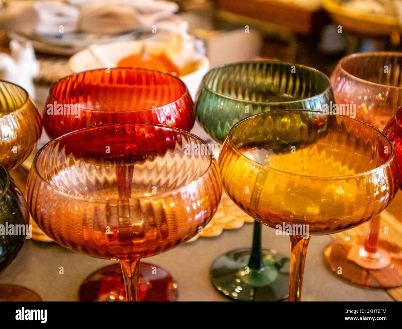 Colorful Glassware in a Vintage Goods store are lined up neatly on ...