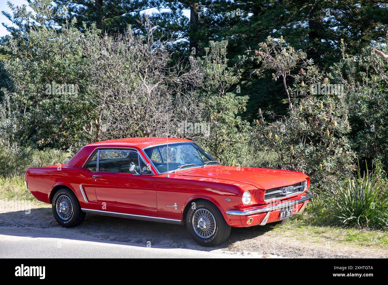 1965 model red Ford Mustang saloon sports car parked in Palm Beach, Sydney,NSW,Australia Stock Photo