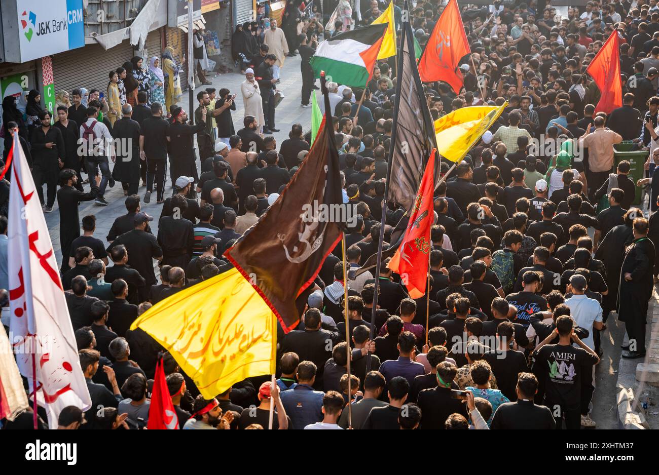 Kashmiri Shia Muslims holding religious flags walk during a Muharram ...