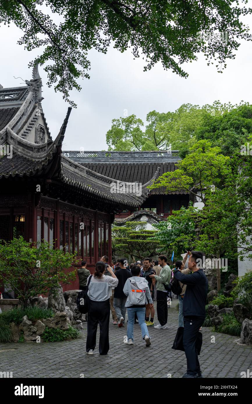 Shanghai, China - June 06, 2024 : Tourists explore the intricate architecture and lush gardens of Yu Garden in Shanghai, China. Stock Photo