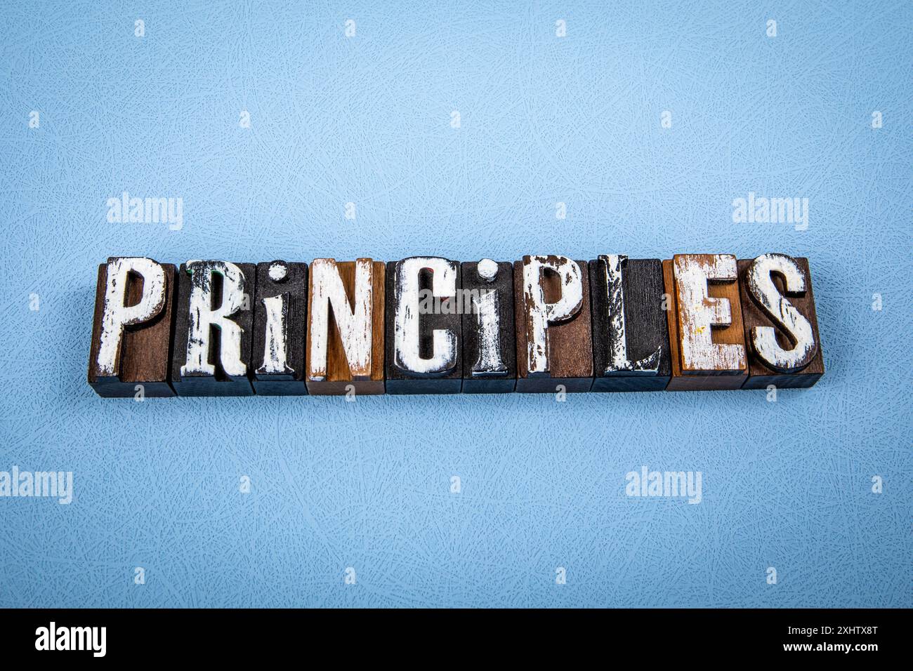PRINCIPLES. Wooden alphabet letter blocks on blue textured background ...