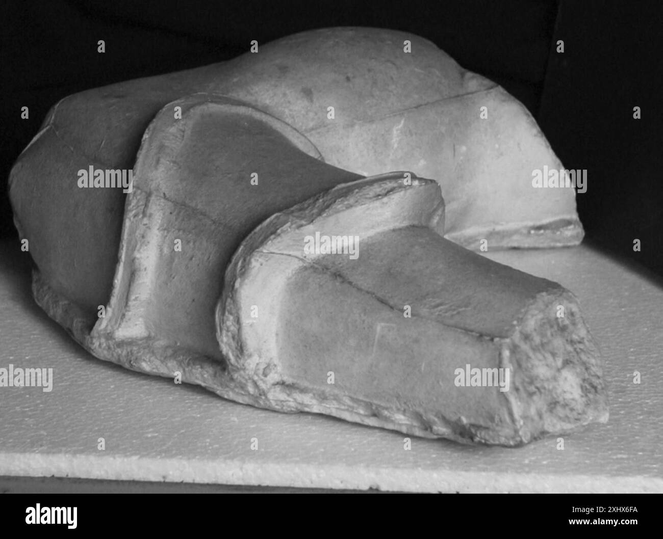 Statue fragment depicting a left arm holding a shield with relief of ...