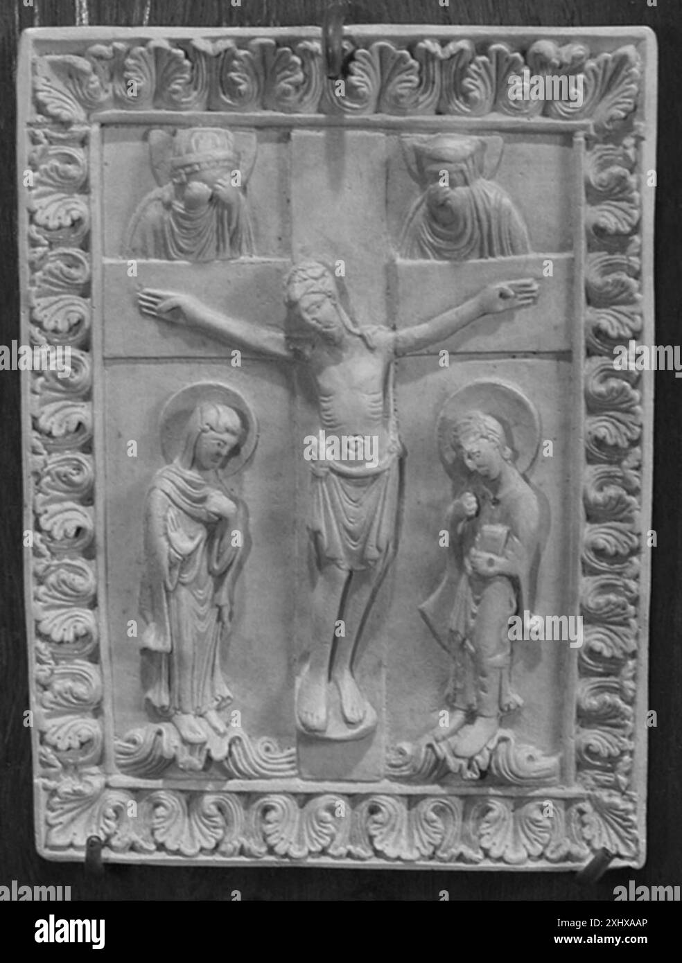Christ on the cross between Mary and John, above the sun and moon that ...