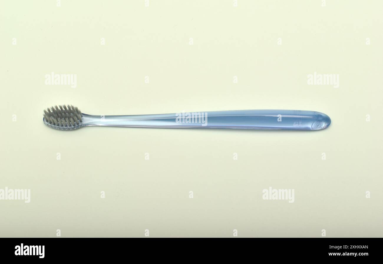 Transparent toothbrush on a green background. Stock Photo