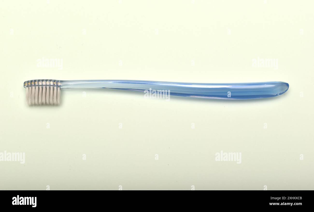 Transparent toothbrush on a green background. Stock Photo