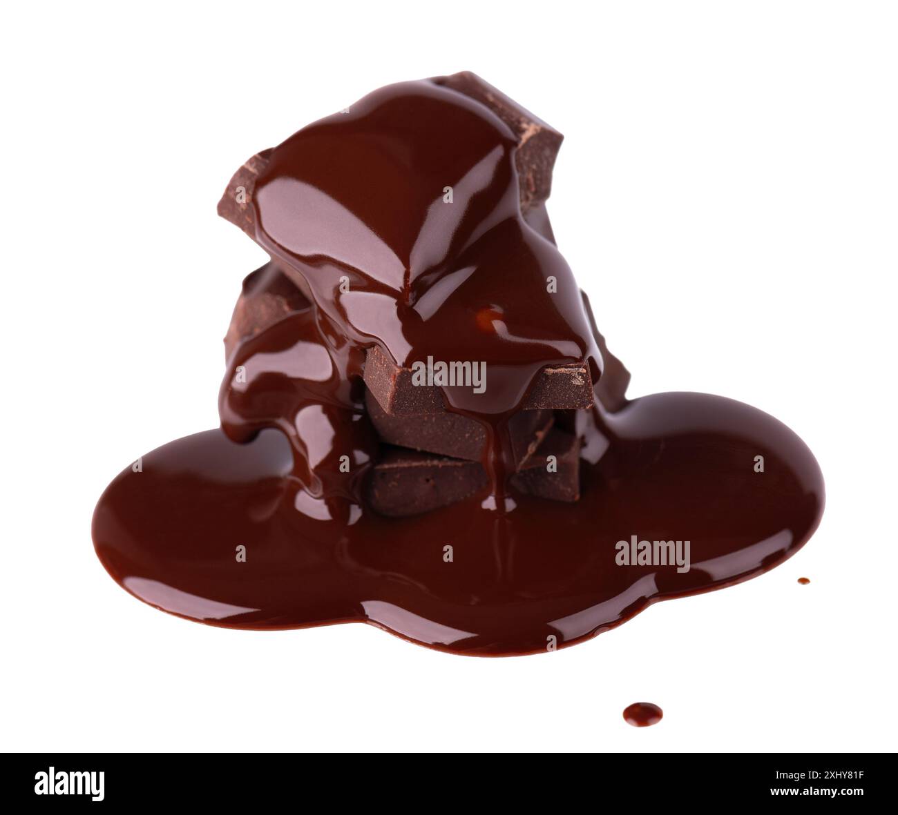 Chocolate pieces stack and chocolate syrup isolated on white background. Close up Stock Photo