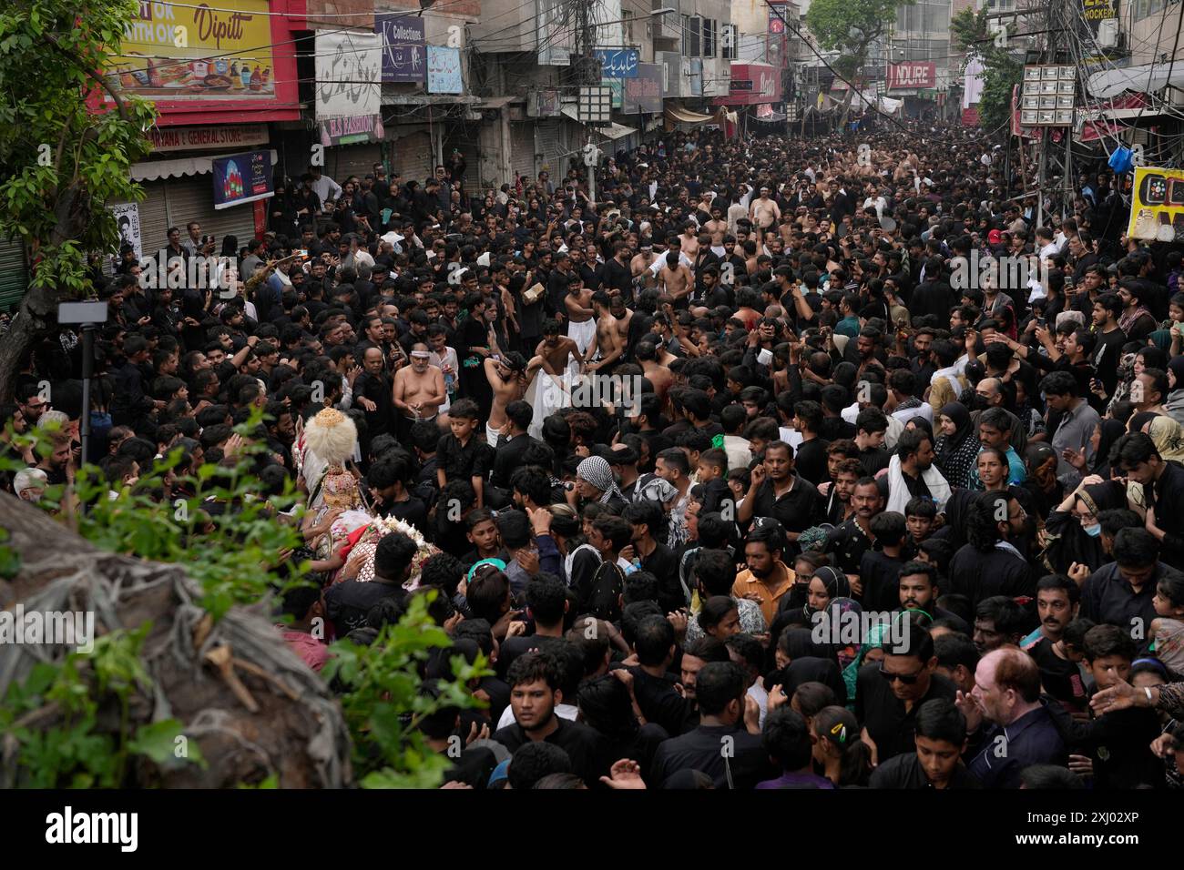 Shiite Muslims participate in a Muharram procession, in Lahore ...