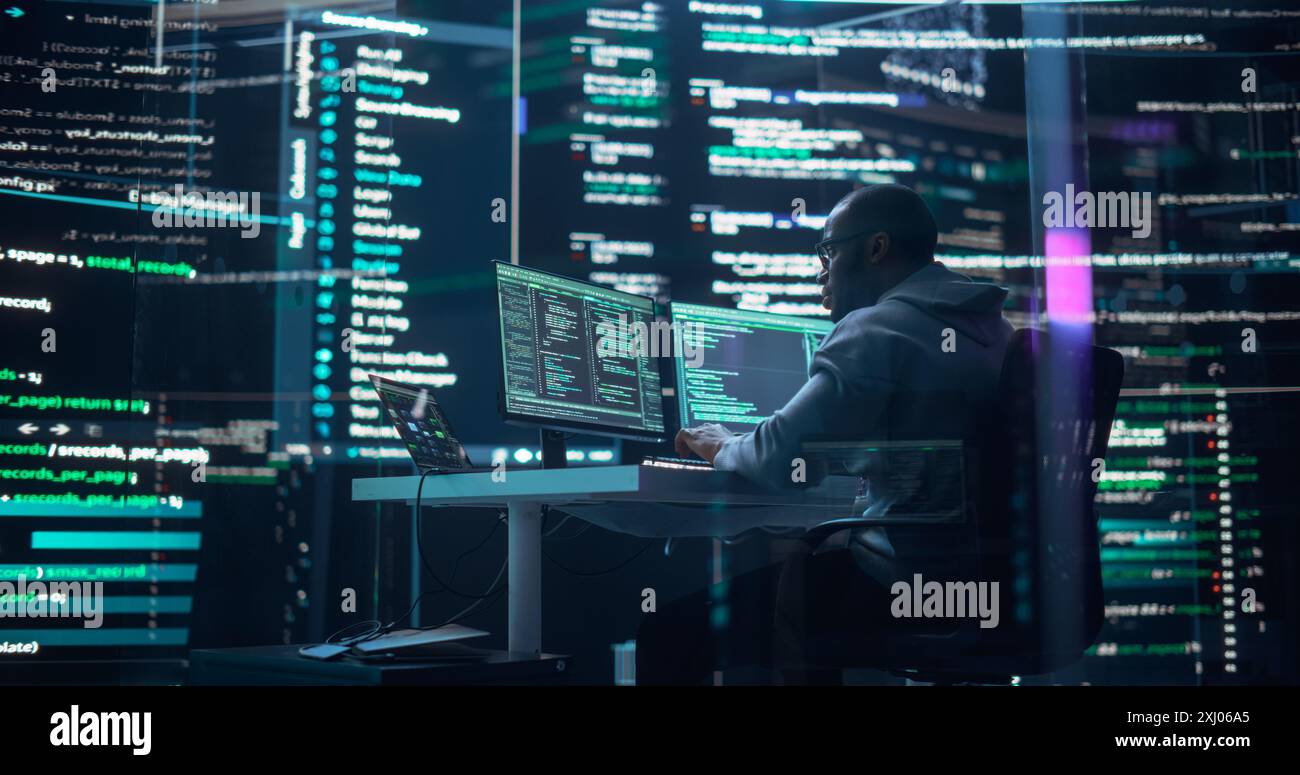 Black Male Developer Thinking and Typing on Computer, Surrounded by Big Screens Showing Coding Language. Professional Programmer Creating Software, Running Coding Tests. Abstract Programming Concept Stock Photo