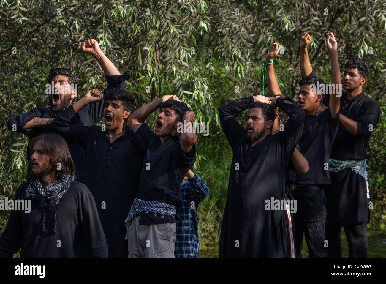 Kashmiri Shiite Muslims shout religious slogans as they participate in ...
