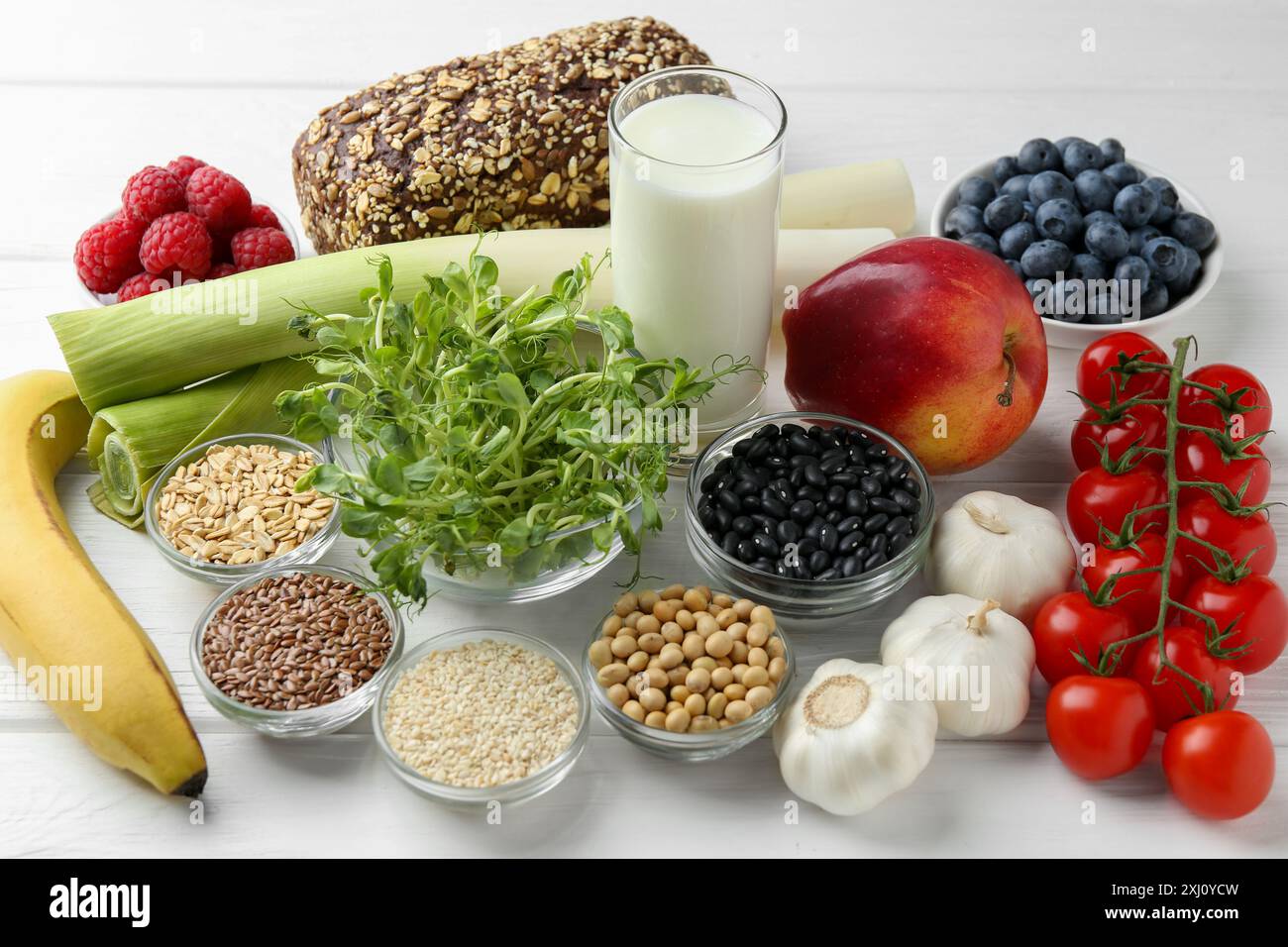 Different fresh products on white wooden table. Source of prebiotics Stock Photo