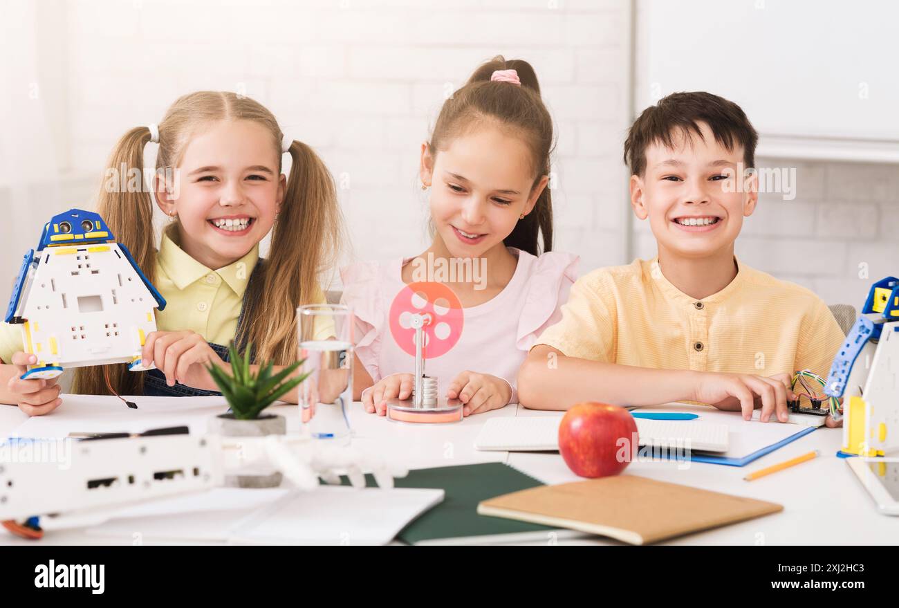 Smiling Children Working On STEM Projects In A Classroom Setting Stock Photo