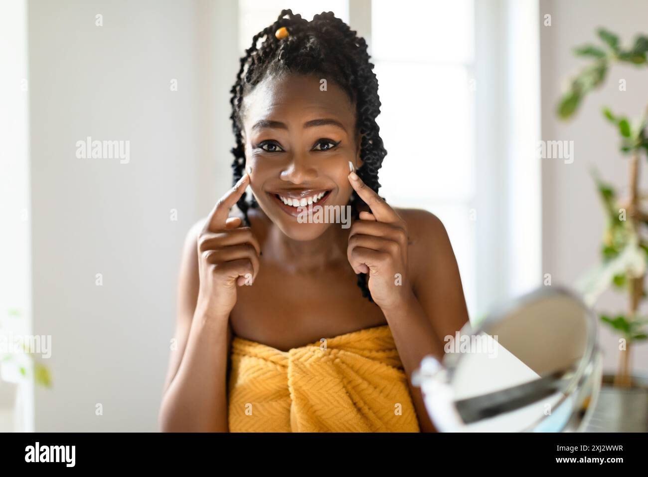 Black woman braids applying cream hi-res stock photography and images ...