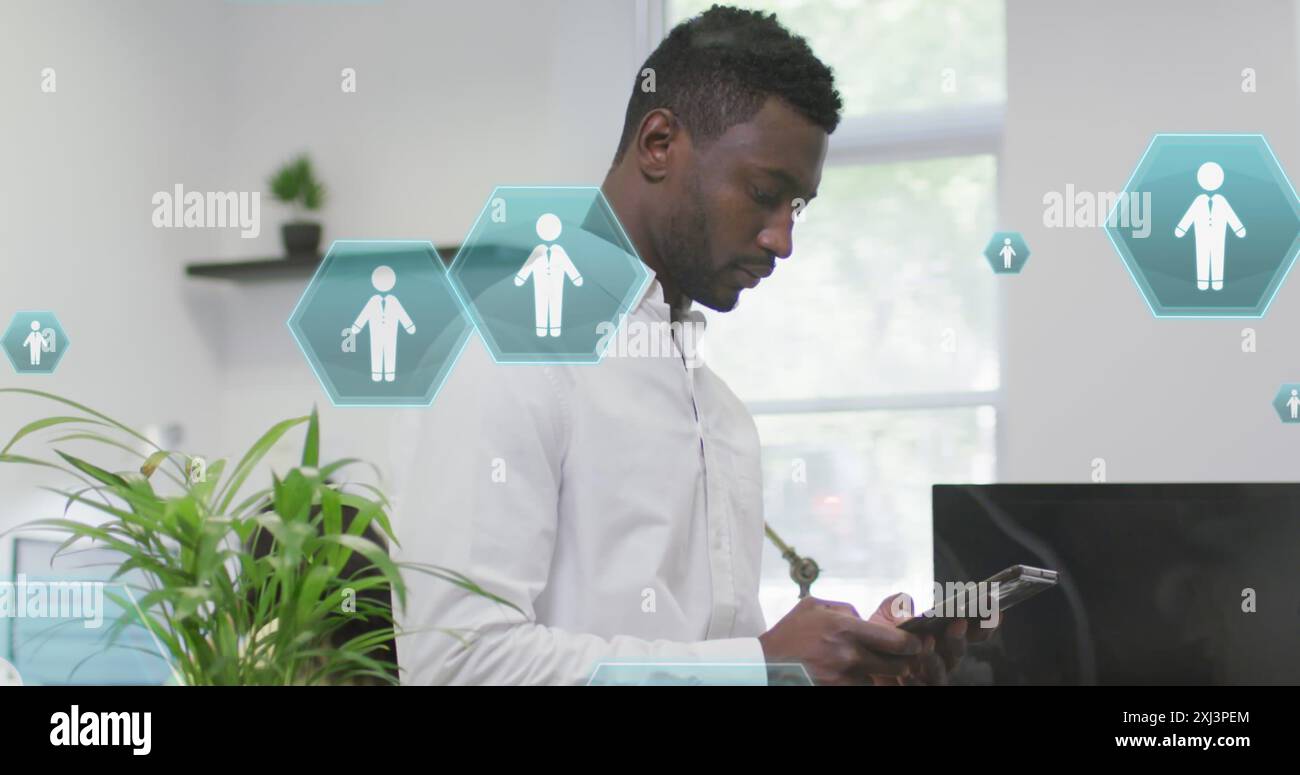 Image of profile icons floating against african american man using digital tablet at office. Global networking and business technology concept Stock Photo
