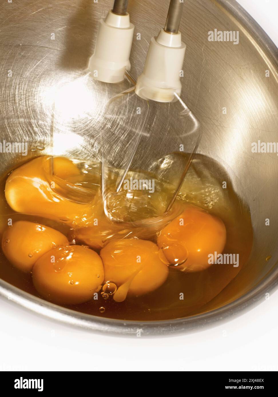 Beating eggs with an elctric whisk Stock Photo