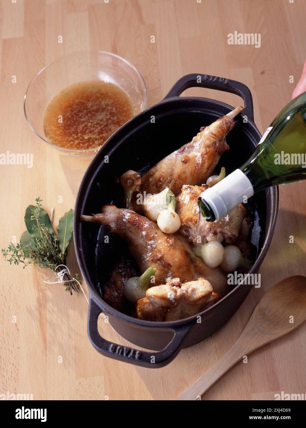 Pouring white wine on the rabbit Stock Photo - Alamy