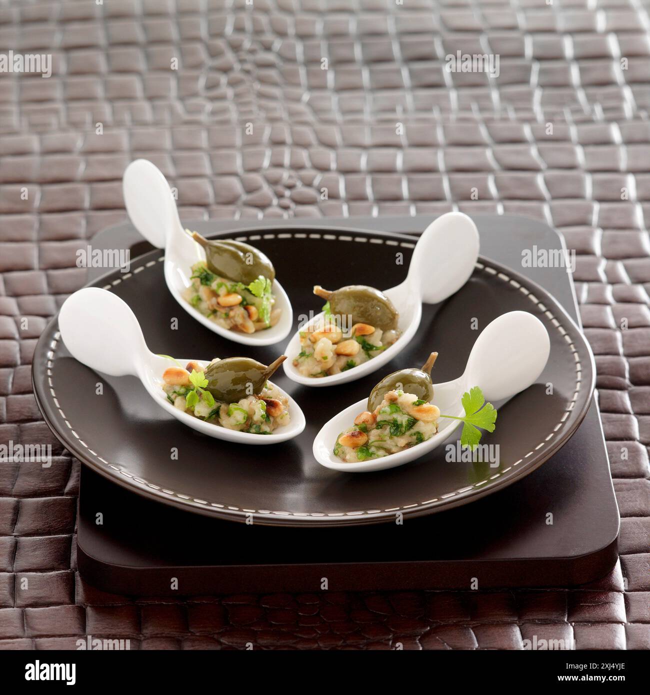 Eggplant puree with pine nuts and capers Stock Photo