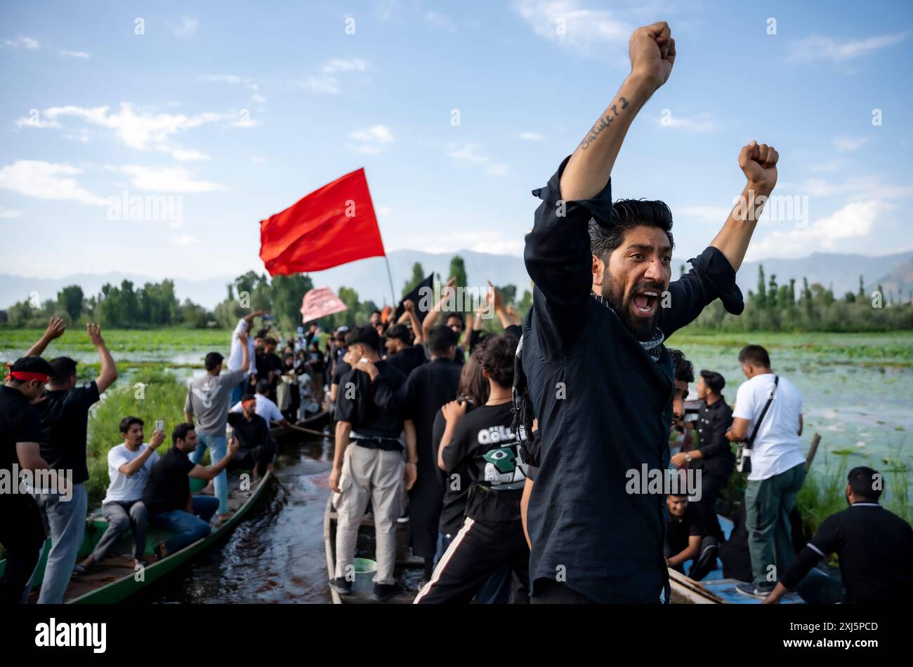A Kashmiri Shia Muslim man shouts religious slogans during a procession ...